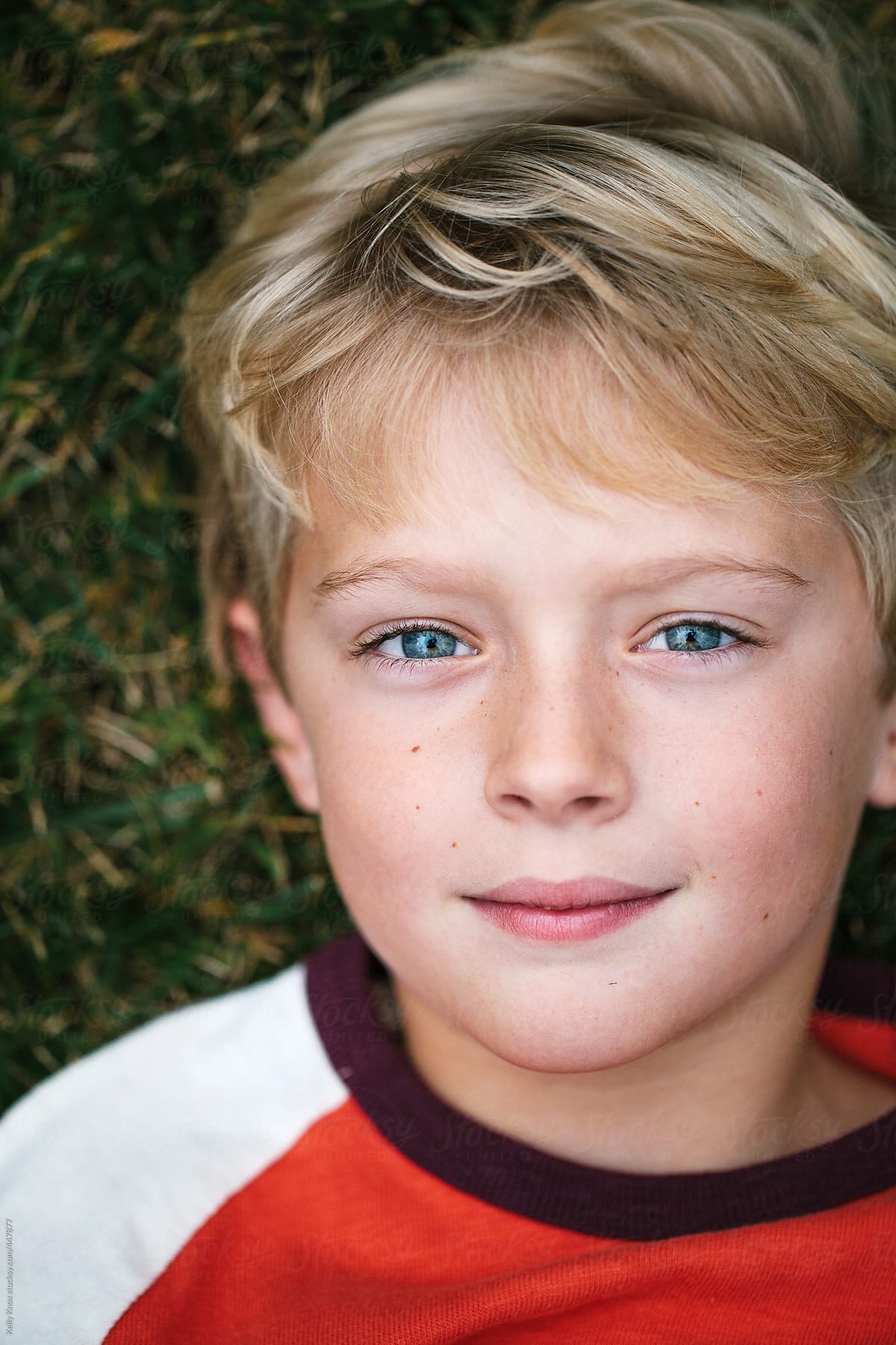 Close Up Overhead Portrait Of A Boy Lying In The Grass By Stocksy