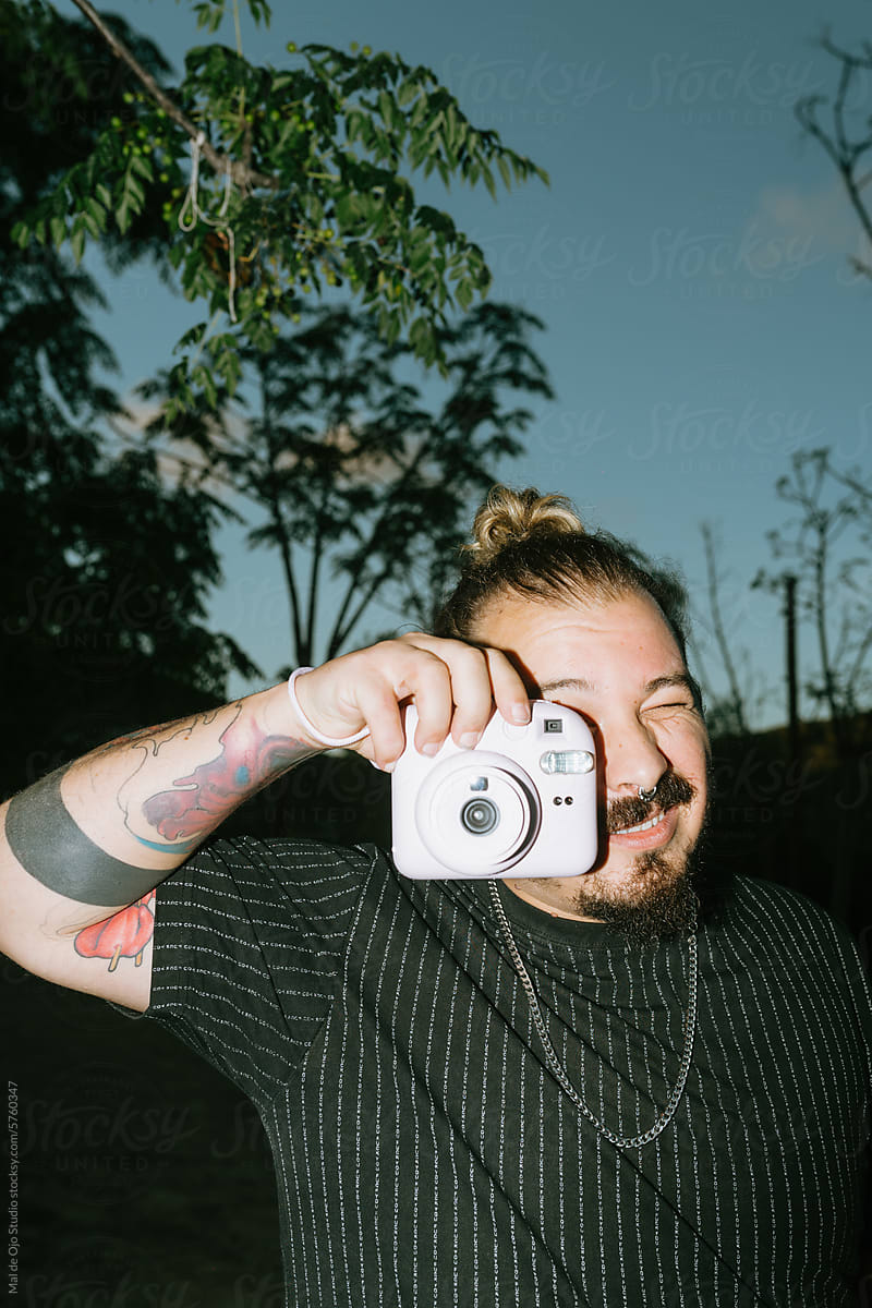 Man Taking a Picture With an Instant Camera
