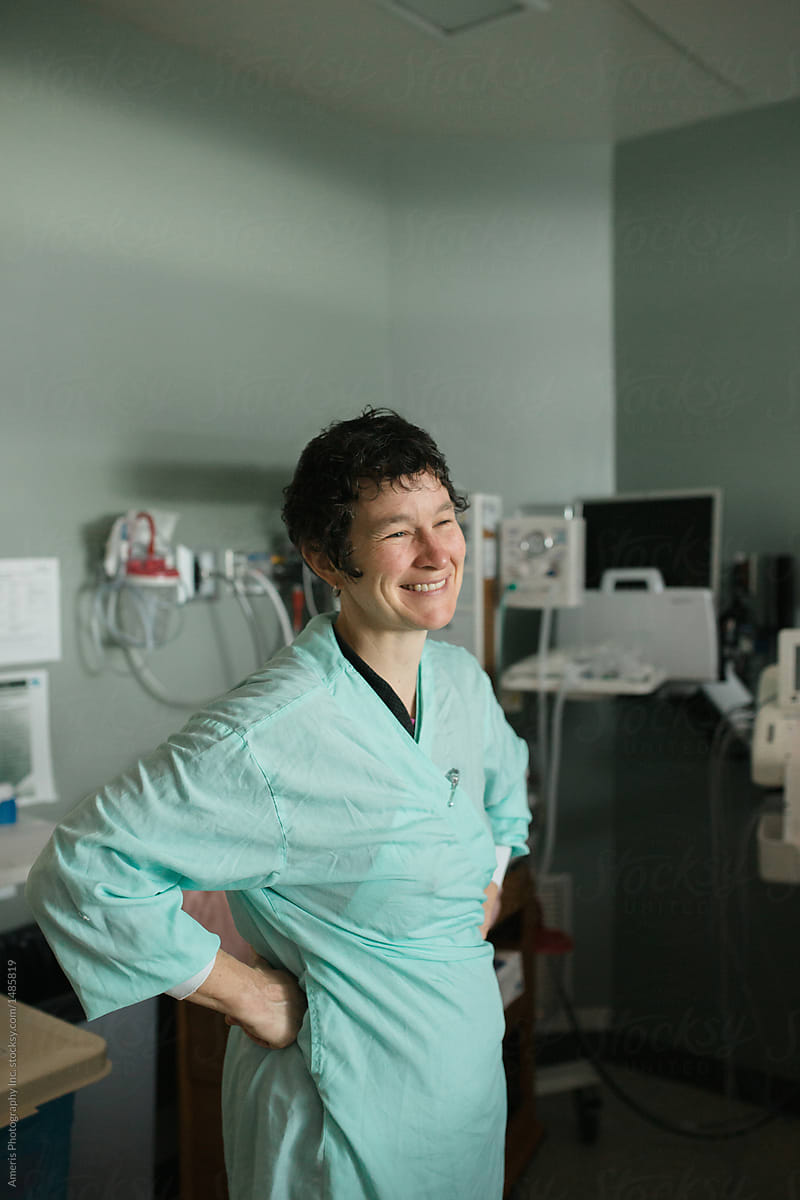 Smiling birth midwife nurse in hospital room