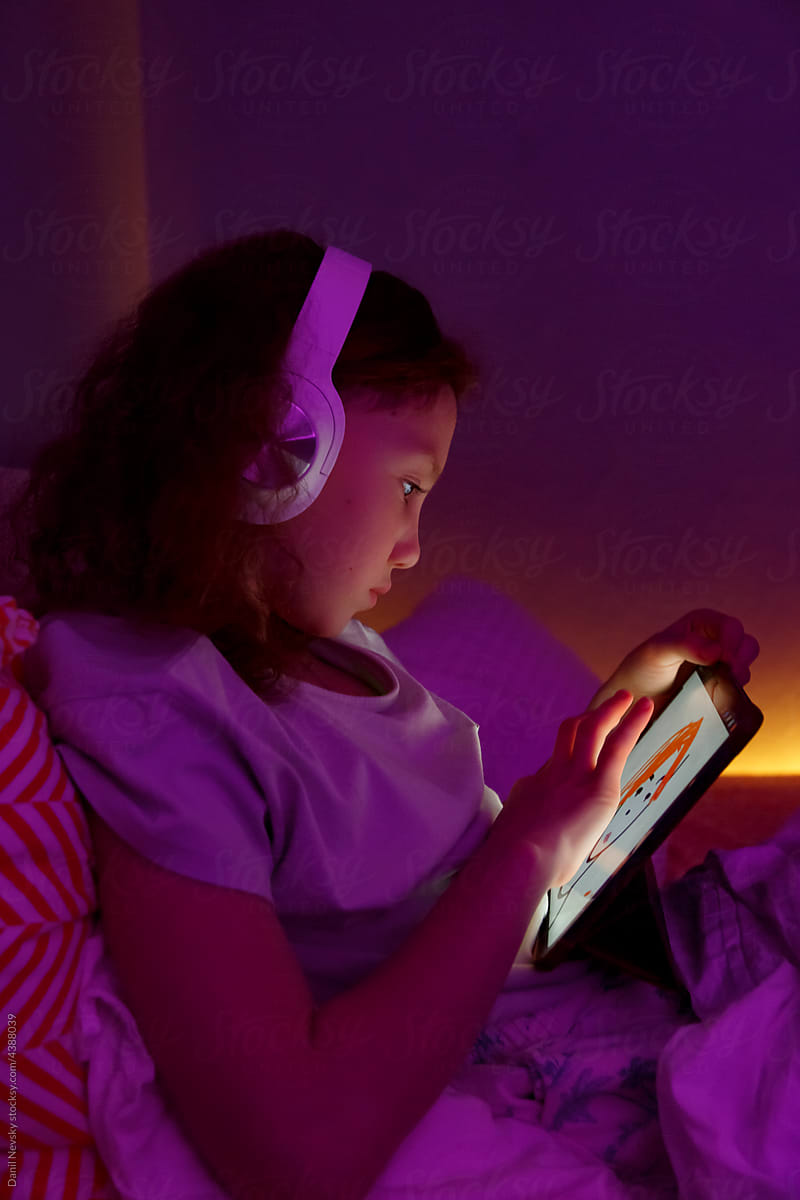 Girl listening to music and sketching at night