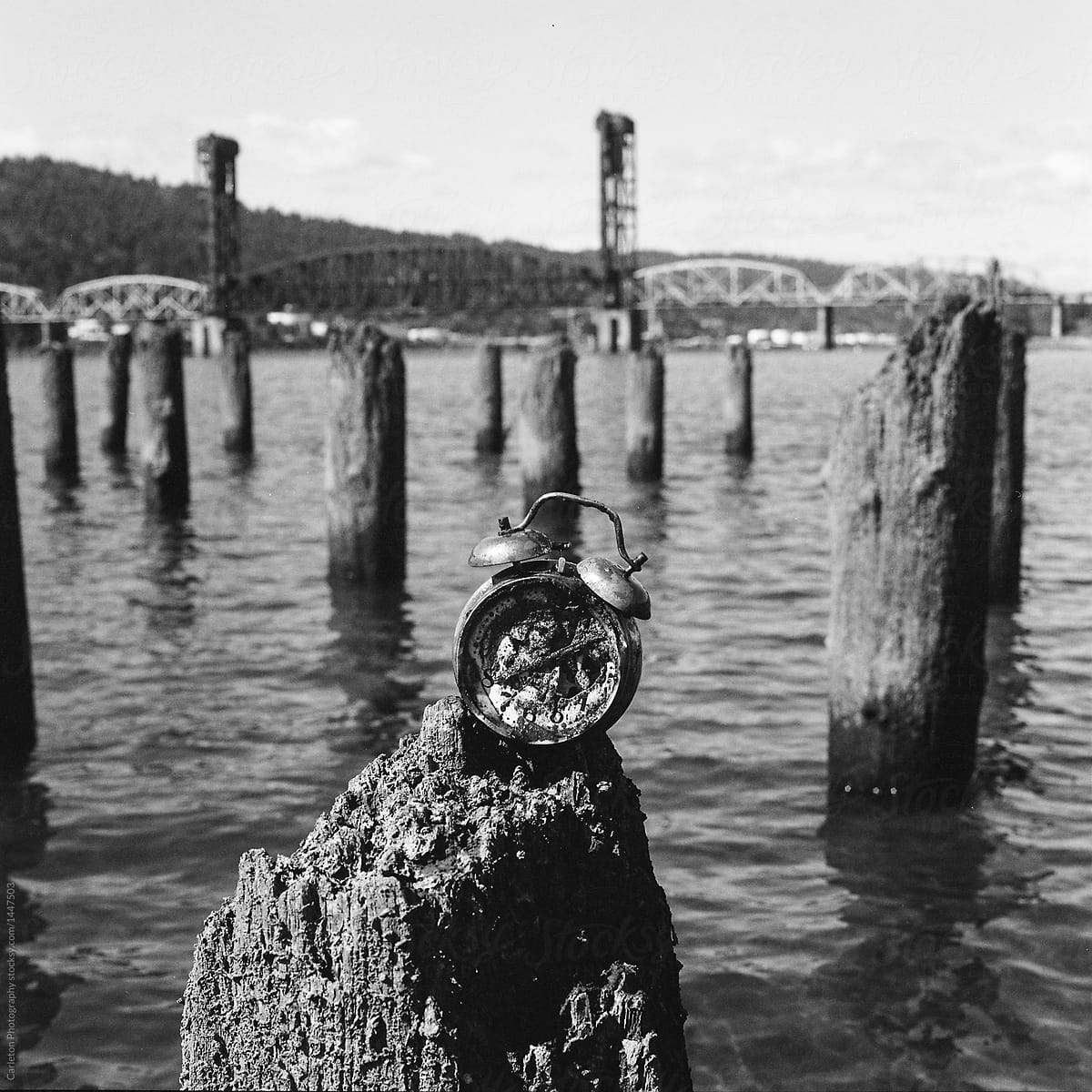 Rusted alarm clock on pilings