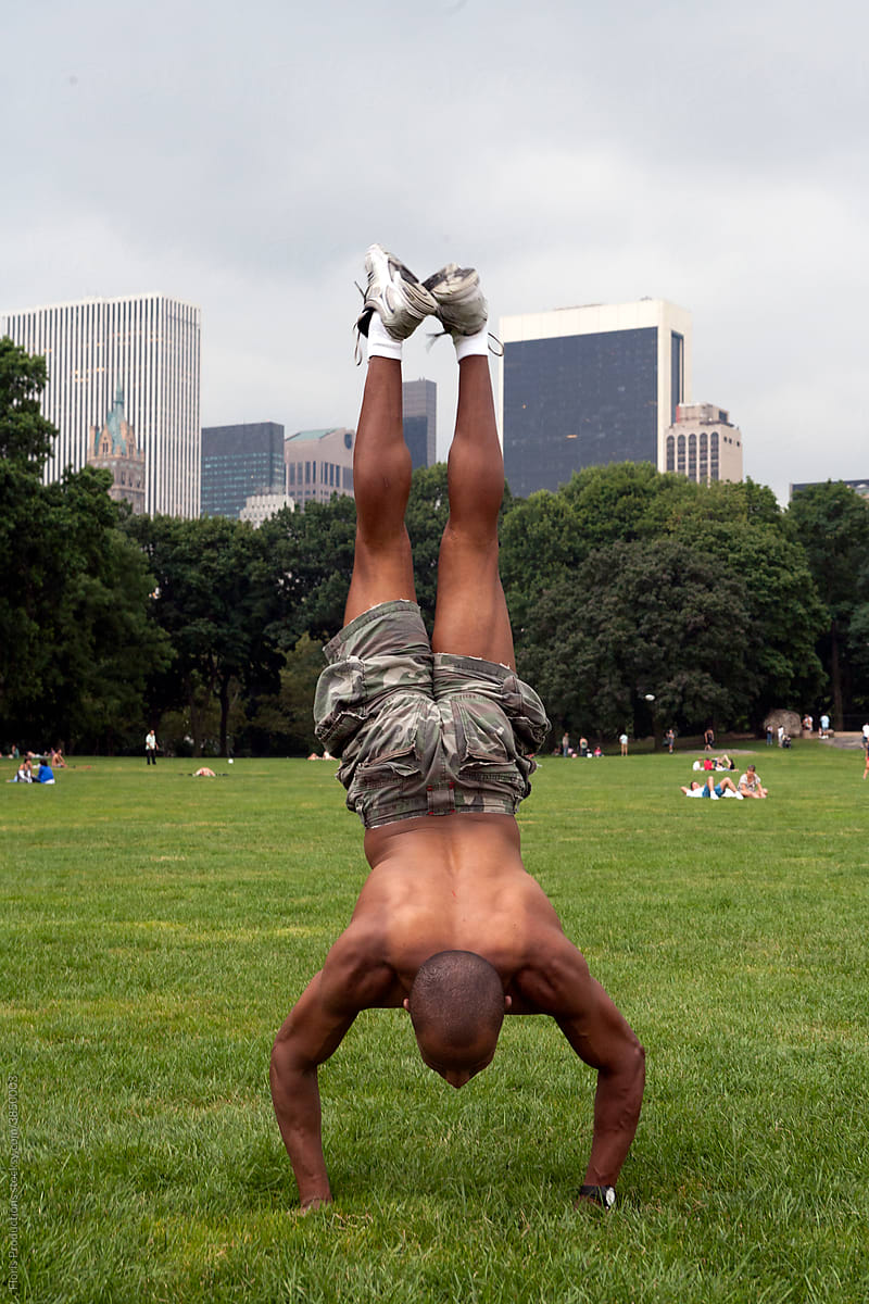 Man doing a handstand in Central park.
