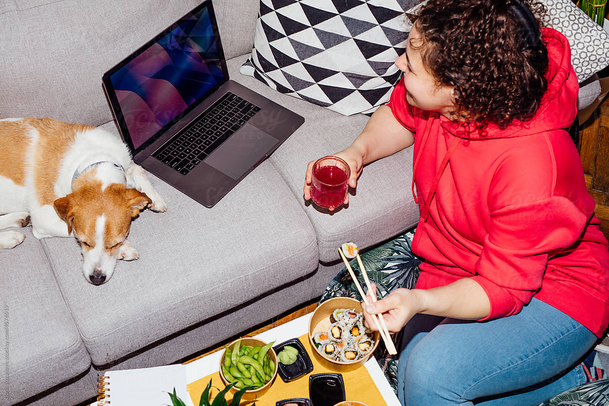 Woman having a meal and watching tv show