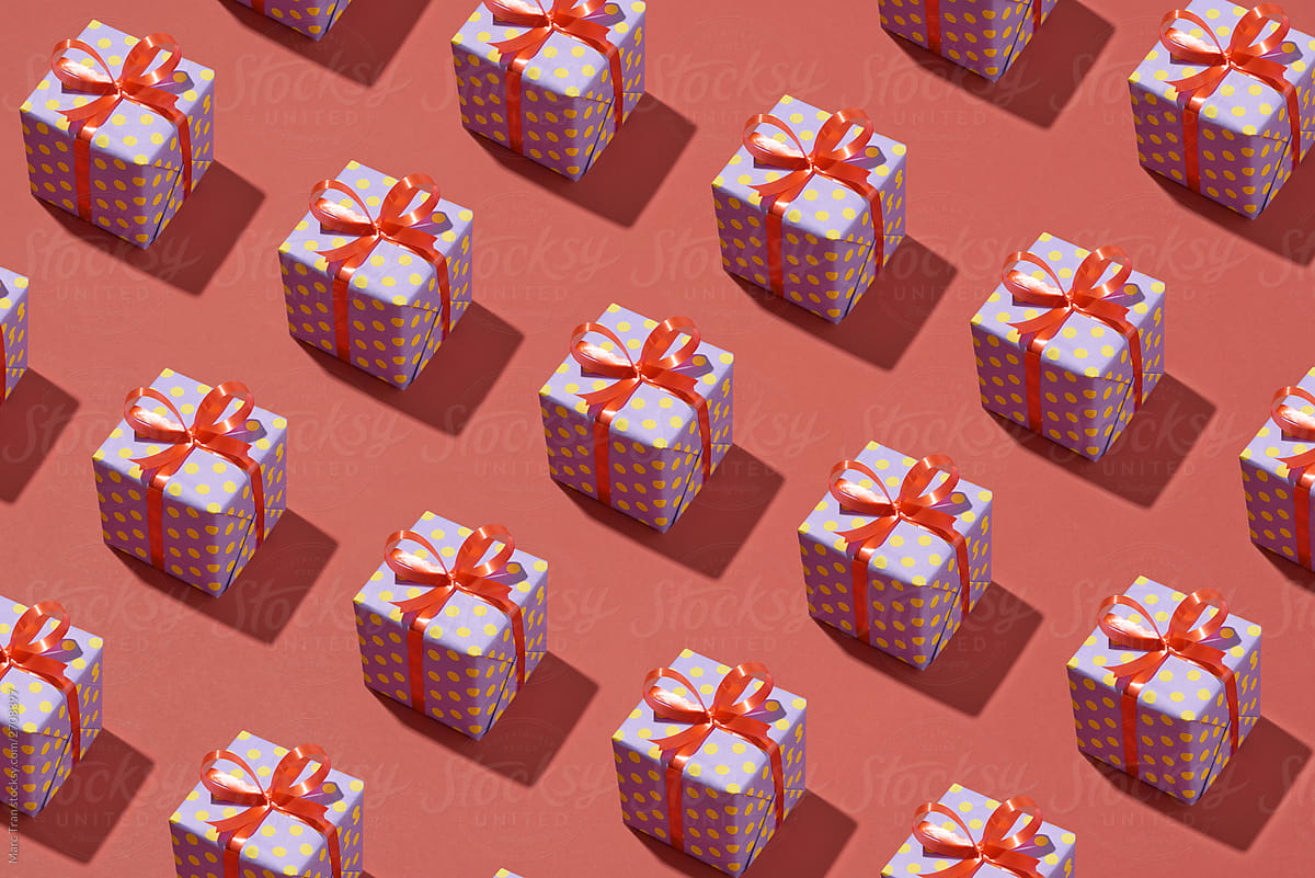 Trendy pattern made from present gift boxes on red background