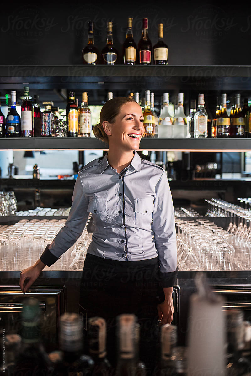 Happy Barmaid Behind the Bar