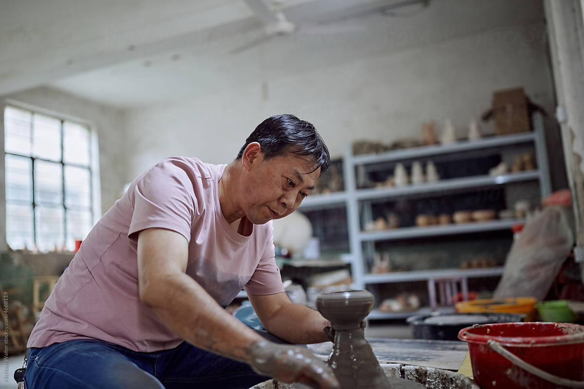 East Asian Small Business Owner Creates Pottery In His Workshop