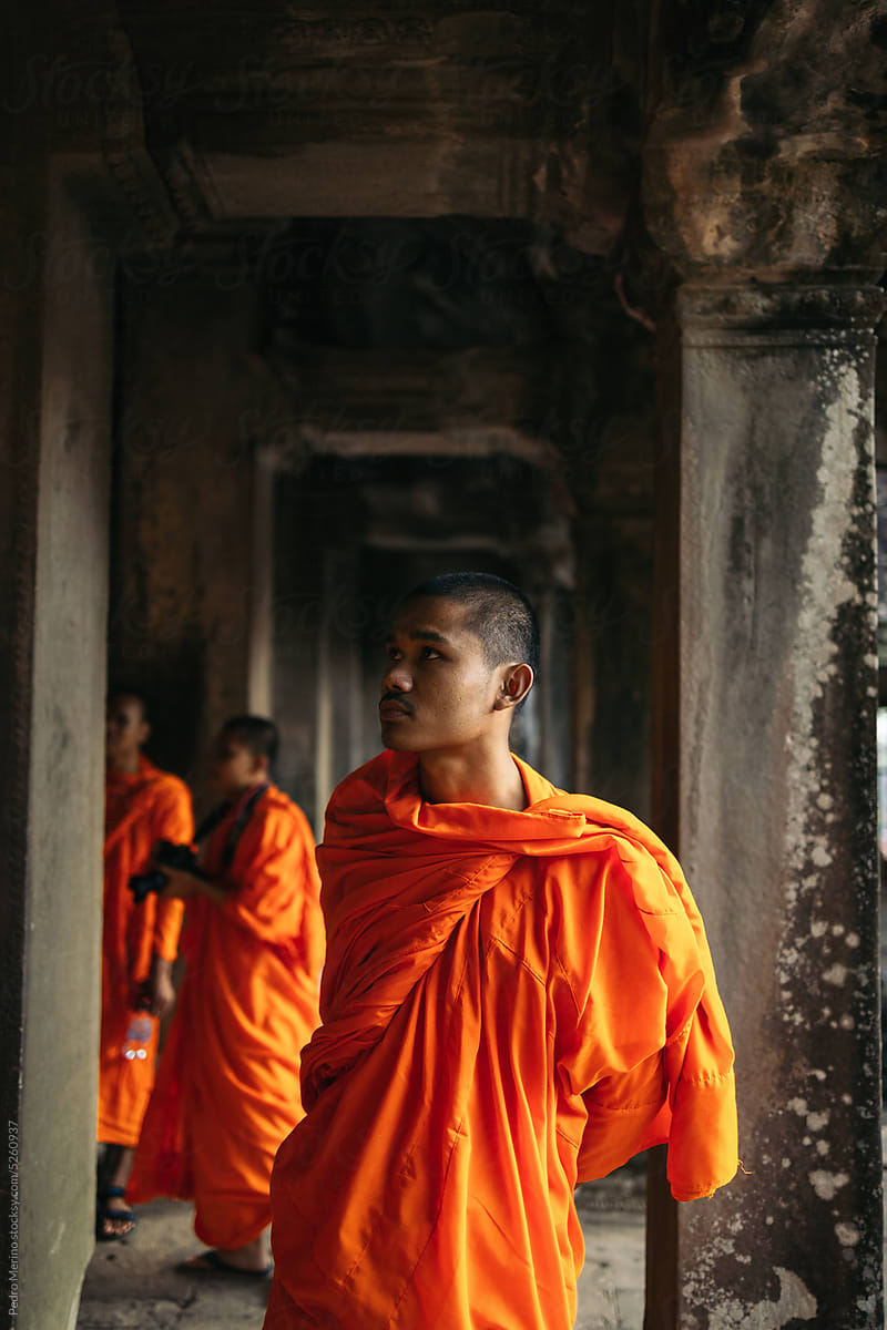 Buddhist monk walking through Angkor Wat temple