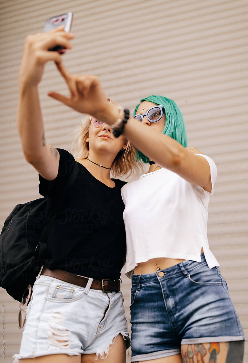 Lesbian Couple Women Making A Selfie On The Street By Stocksy Contributor Alexey Kuzma Stocksy
