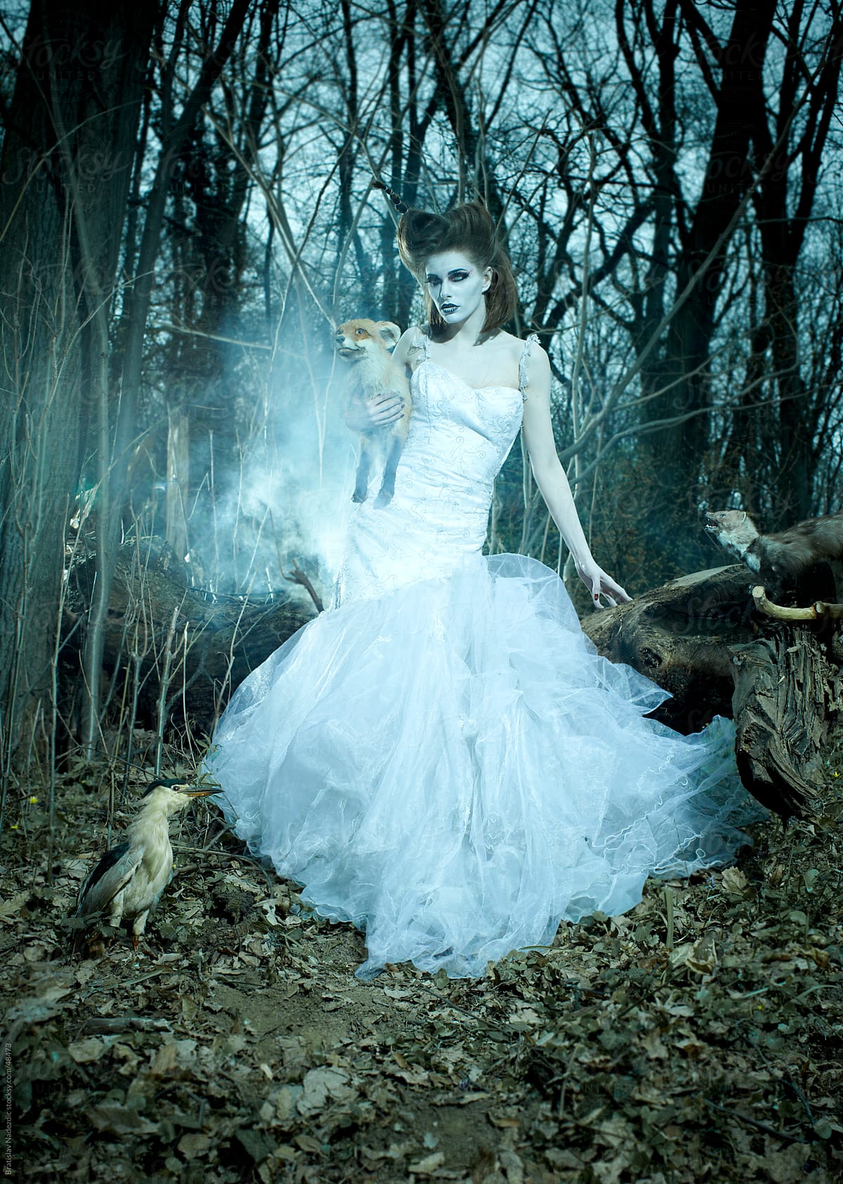 Fairy in white dress in blue forest
