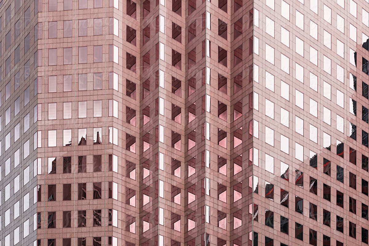 Pink building with glass windows forming patterns