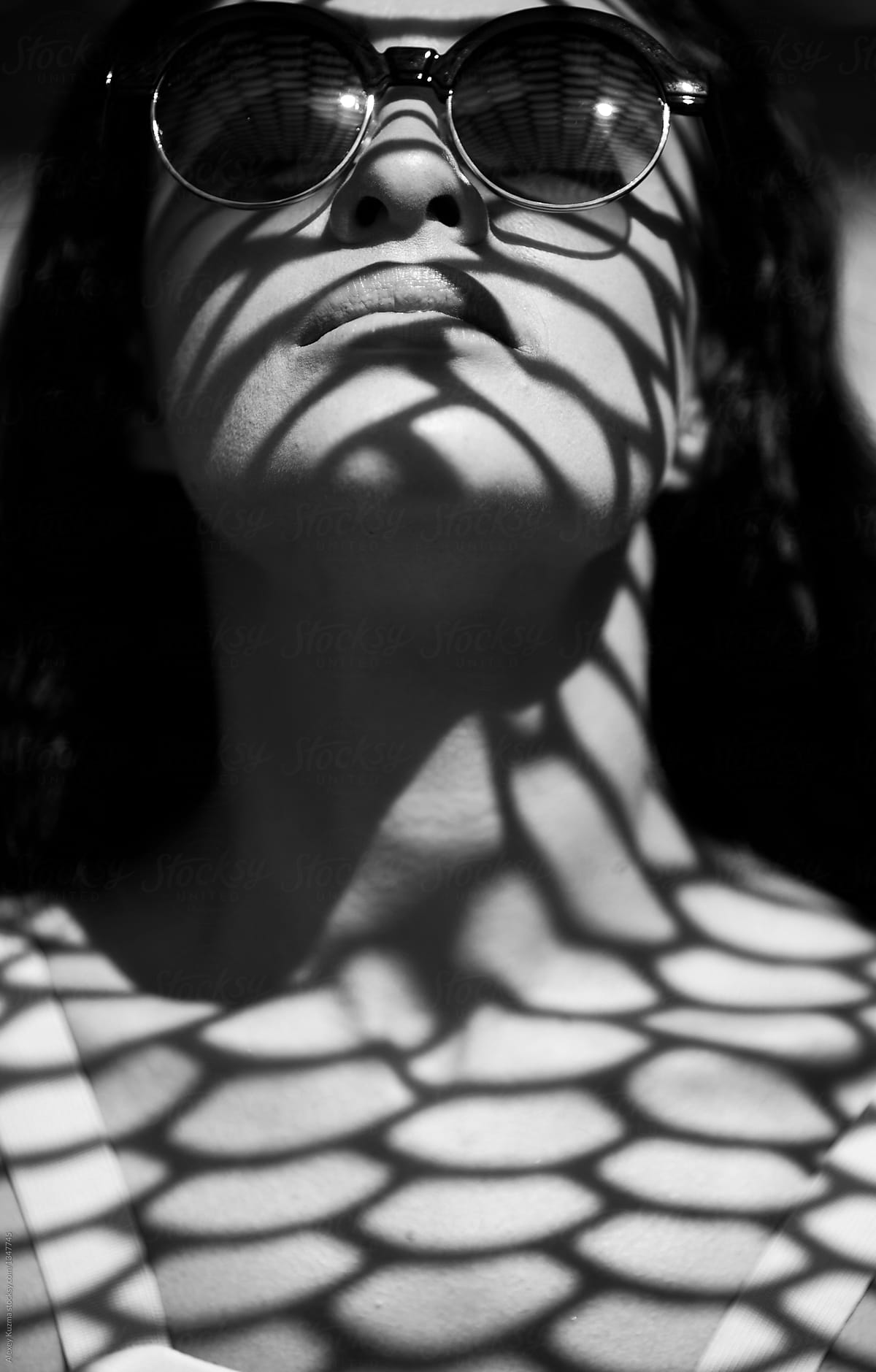 closeup of beautiful woman with a geometric patterned shadow