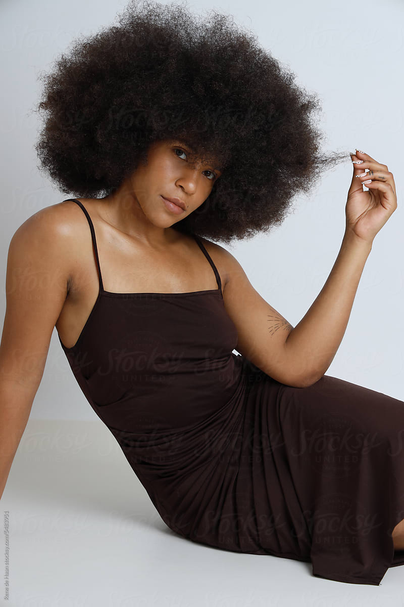 black female with afro, wearing black dress