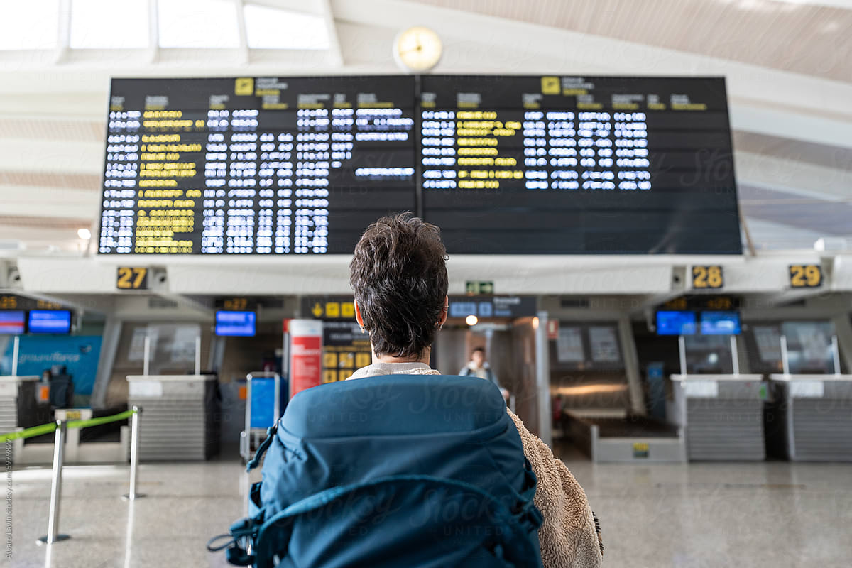 Traveler woman checking flight schedule.