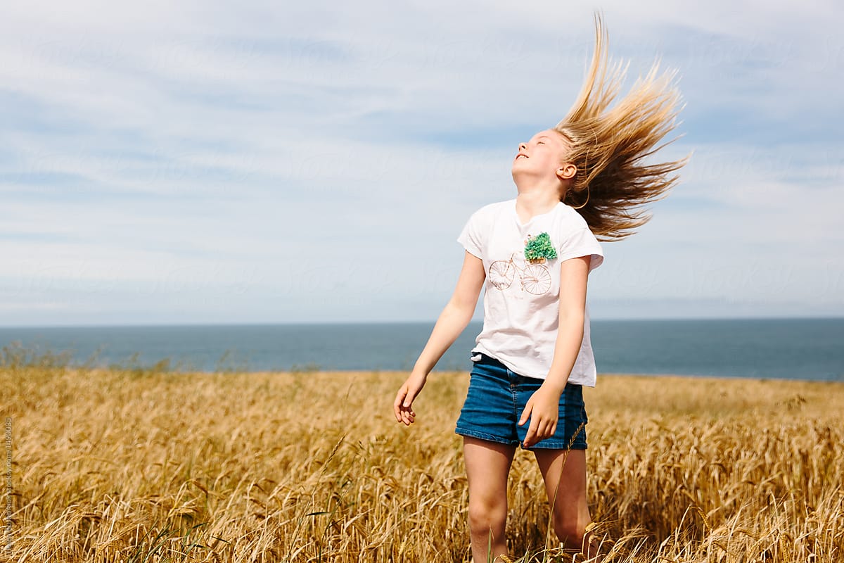 Pre Teen Girl Whipping Her Hair Outdoors In Summer By Helen Rushbrook