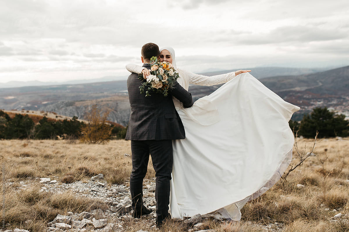 Bride and groom hugging in the mountains