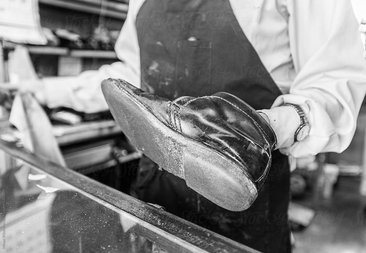 Cobbler shining a leather shoe