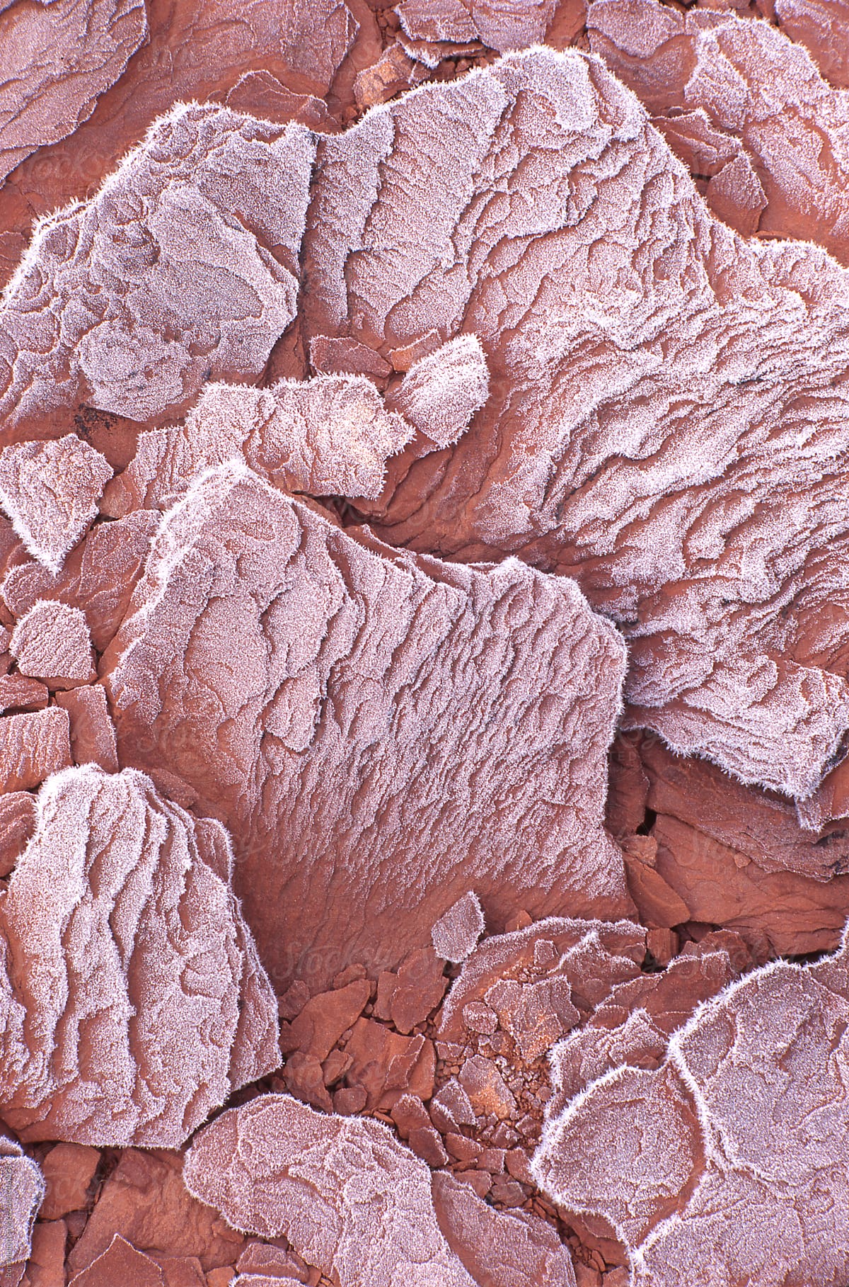 closeup macro of frost crystals covered red sandstone in Utah desert southwest winter