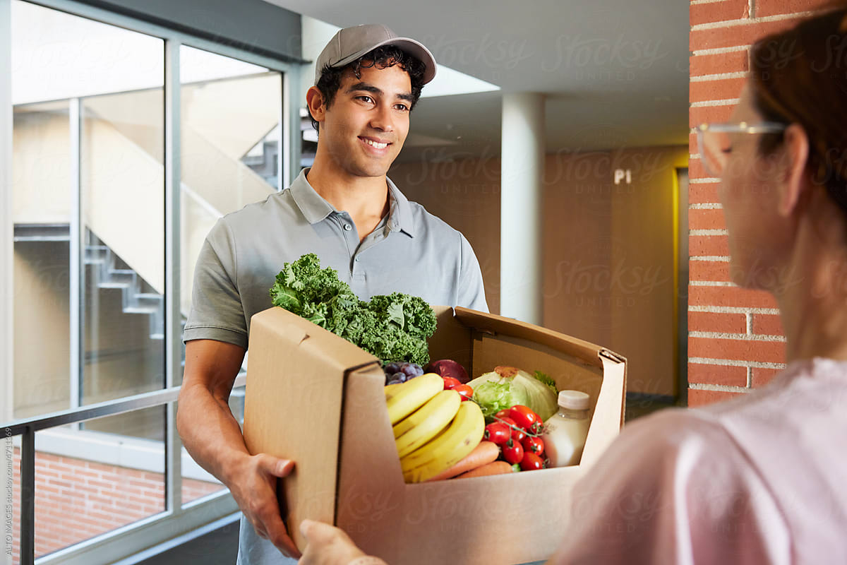 Hispanic courier delivering fresh food to client