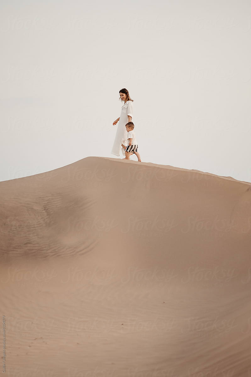 Mother and son on sand dune.