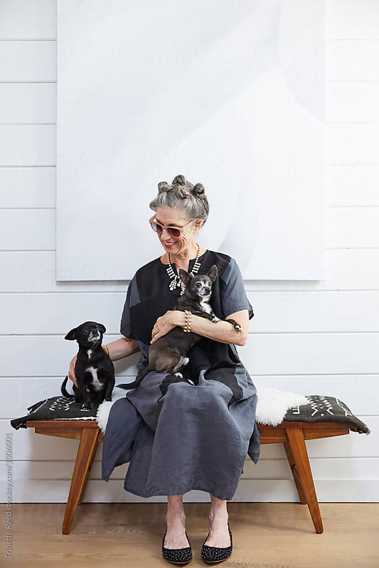 Portrait of stylish senior woman with her pet dogs
