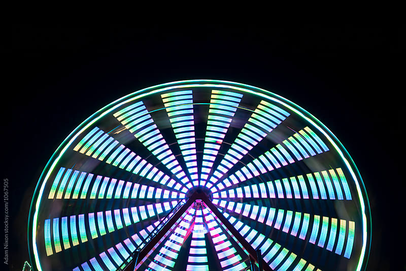 Spinning ferris wheel at night, abstract