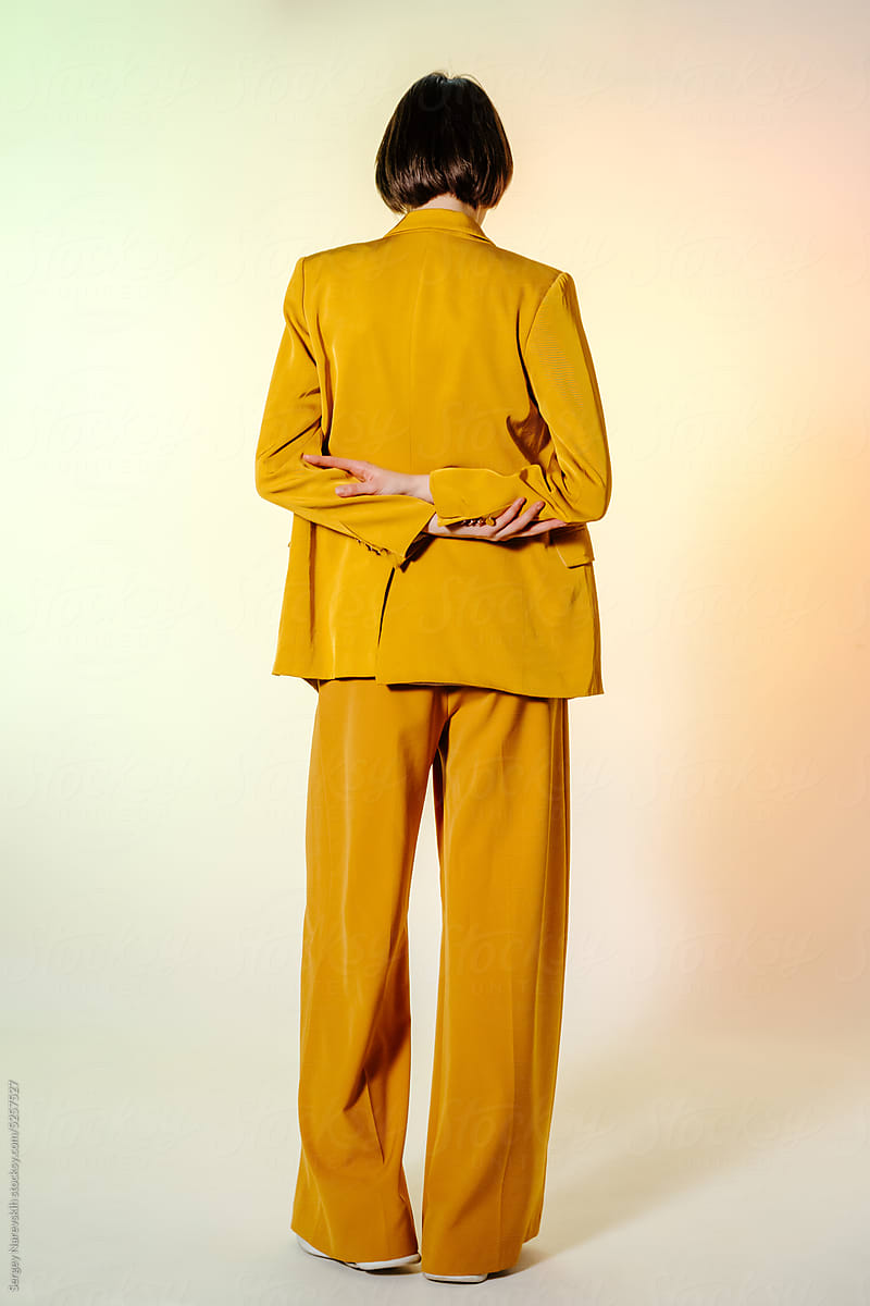 Anonymous female model in yellow suit