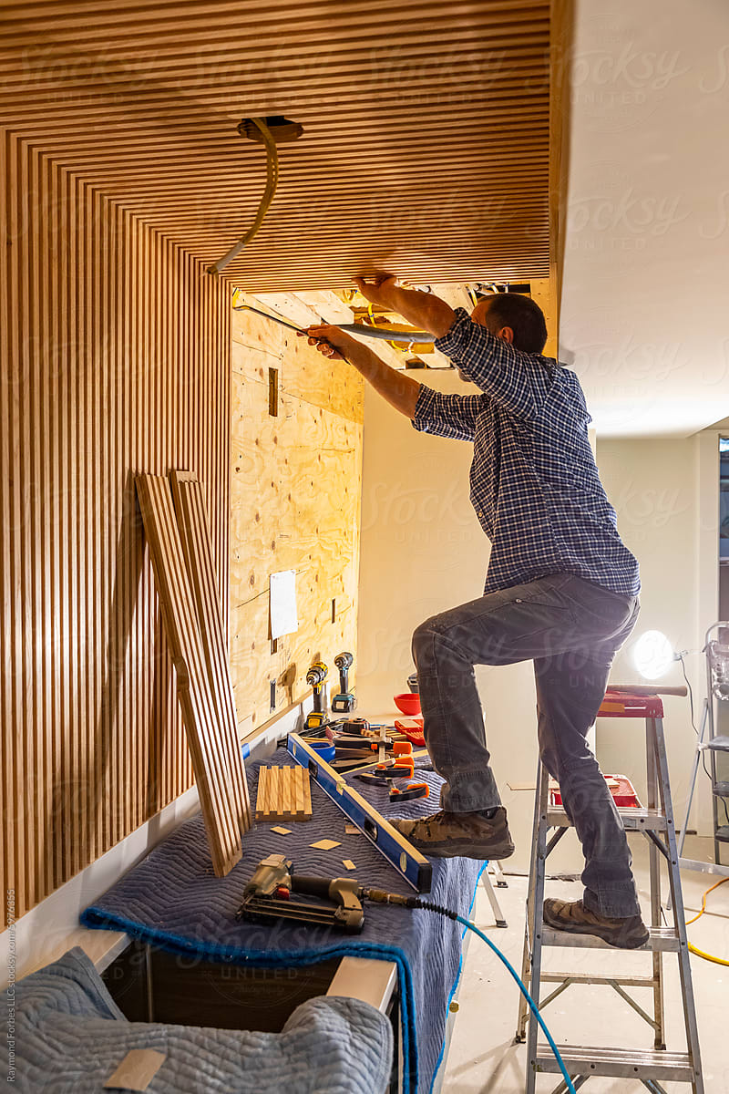 Carpenter worker building Vertical wood paneling wall