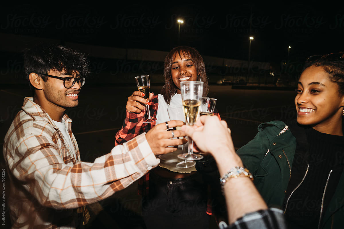 Cheerful friends clinking glasses of champagne