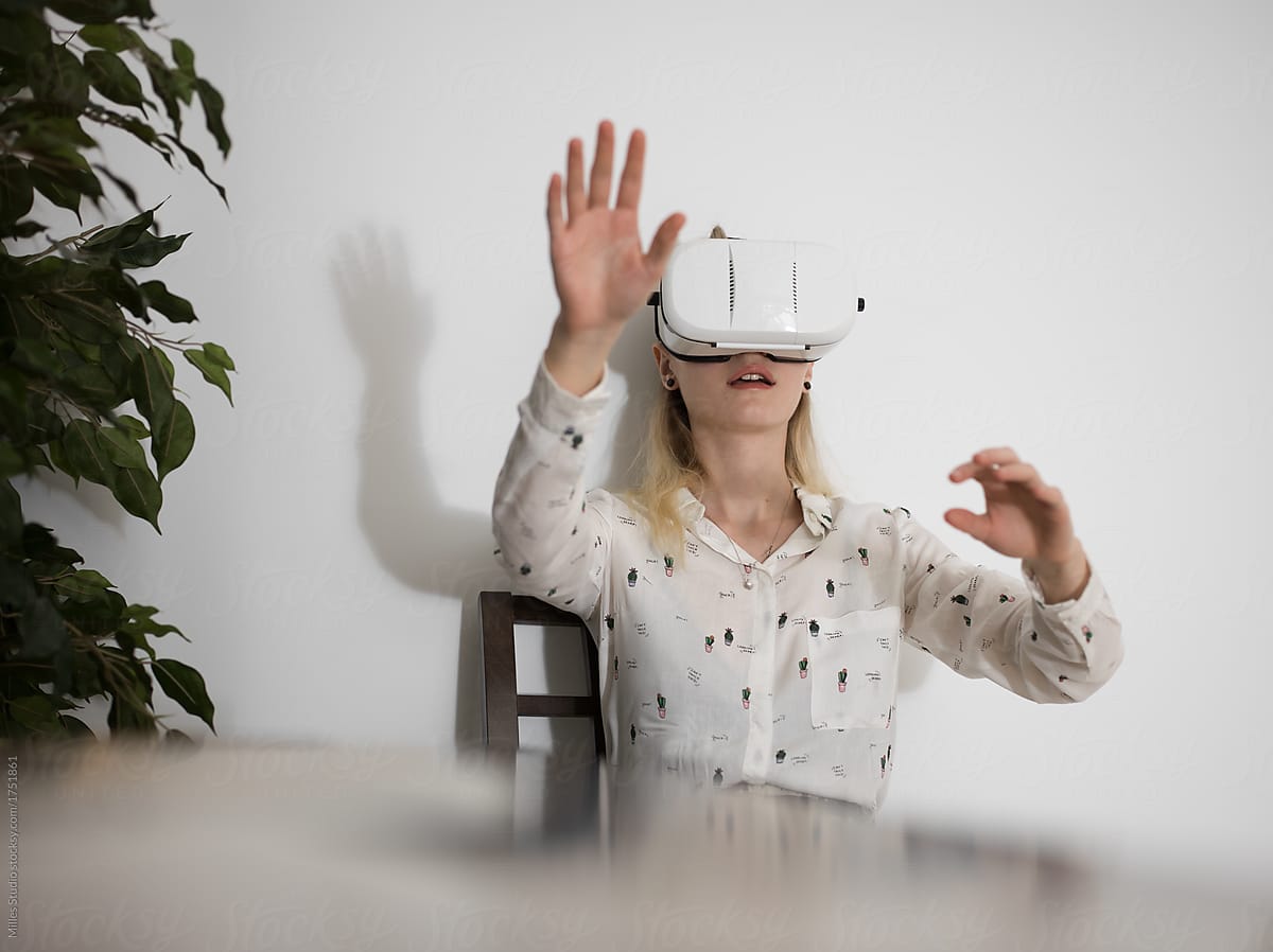 Woman Experiencing Virtual Reality In Glasses By Stocksy Contributor Milles Studio Stocksy