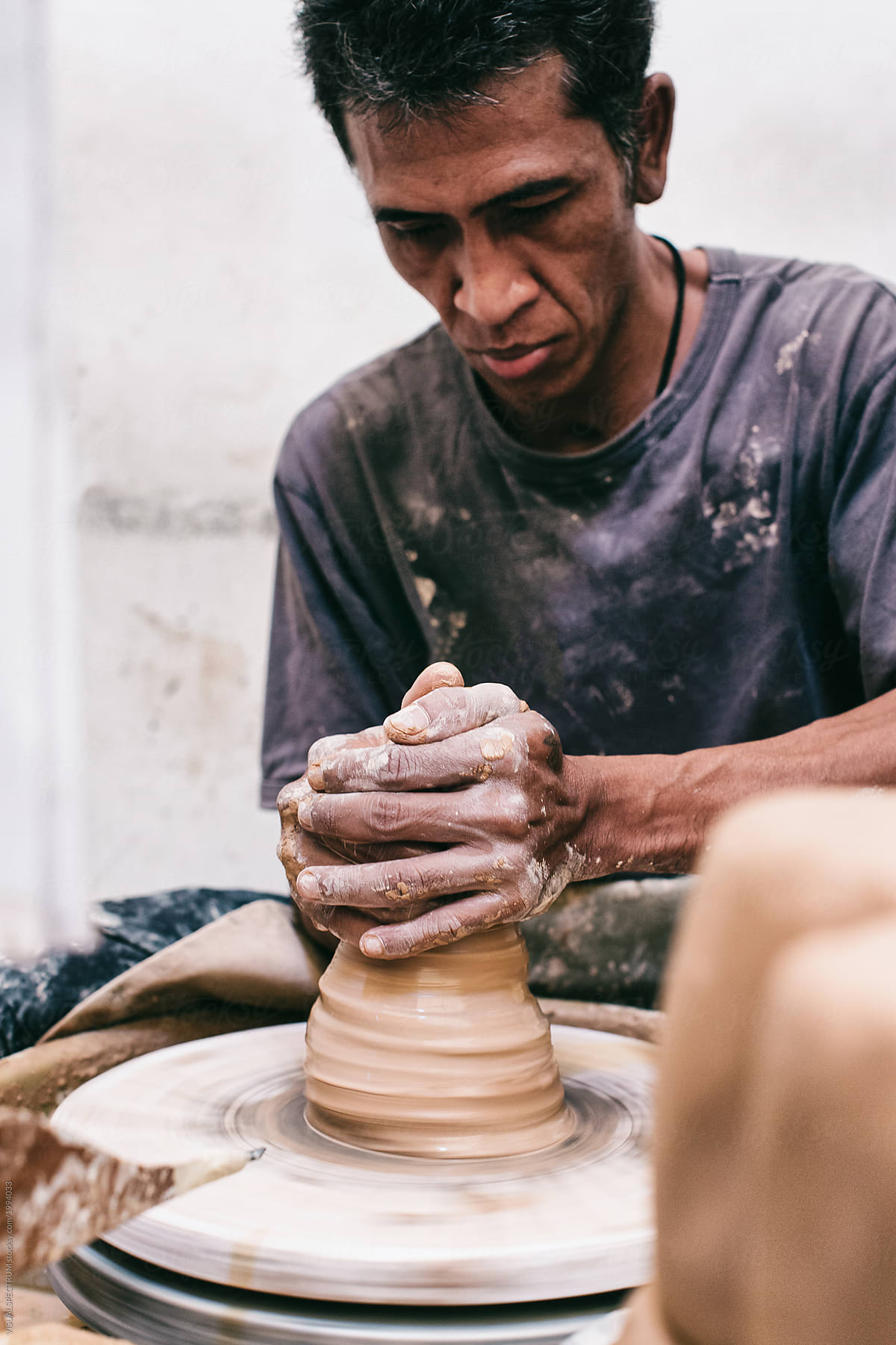 South East Asian Potter at Work on Flywheel