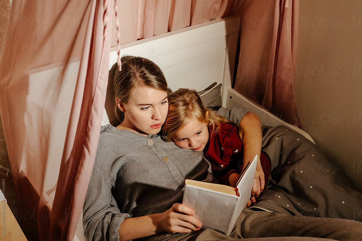 Mother and daughter reading fairy tale