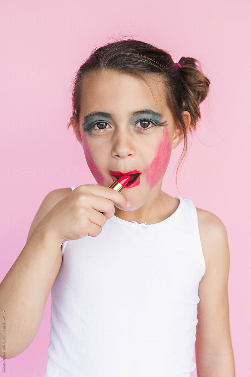 A Girl Putting On Lipstick And Getting It All Over Her Face By Stocksy Contributor Alison 
