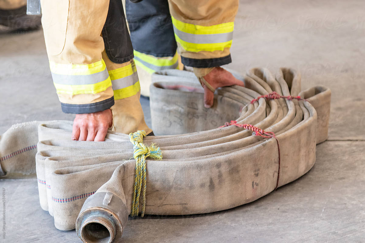 Close Up Of Firefighter\'s Hands Holding A Segment Of Hose