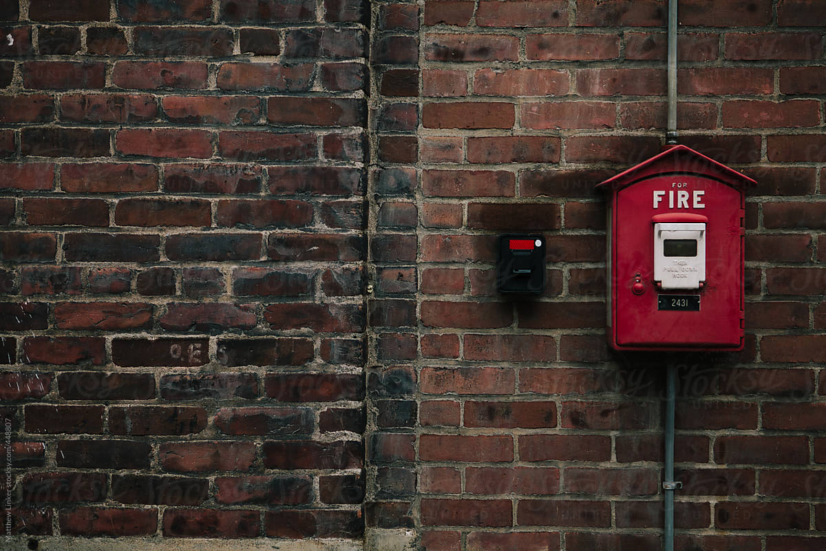 Fire alarm on a brick wall