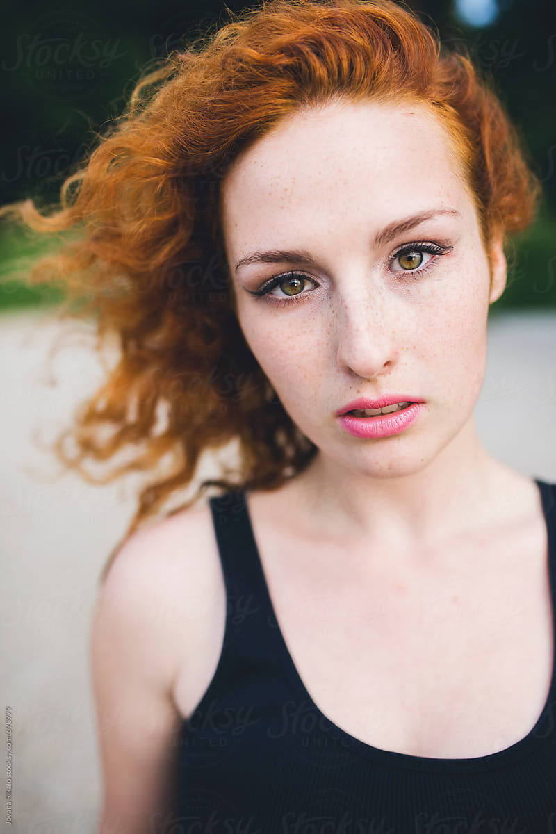 Portrait of a beautiful young woman with freckles and ginger hair