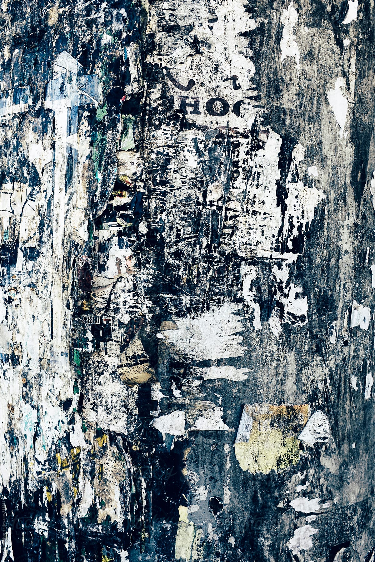 Close up peeling and decaying posters on building wall