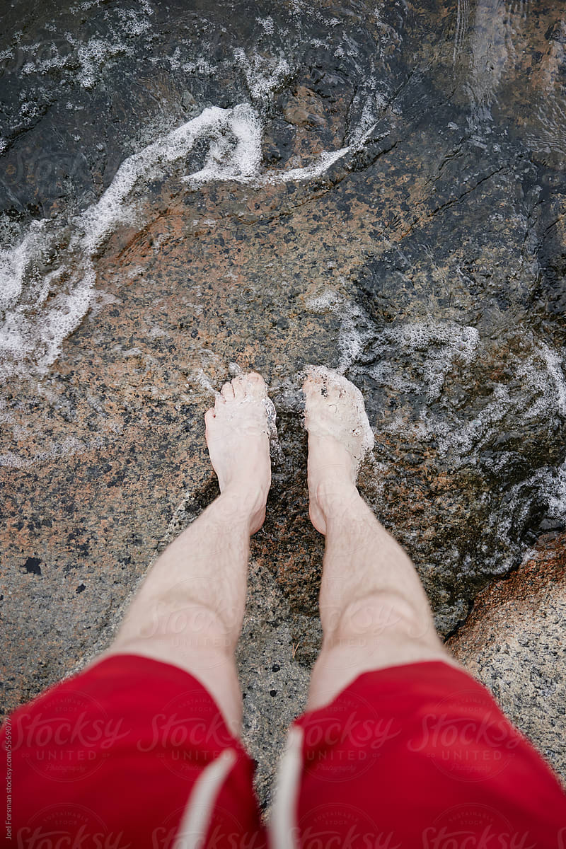 white man's feet in water
