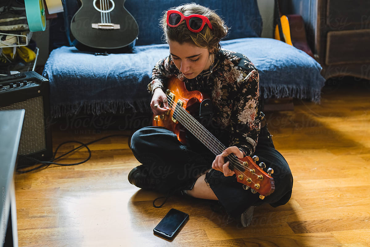Young Woman Learning to Play Guitar