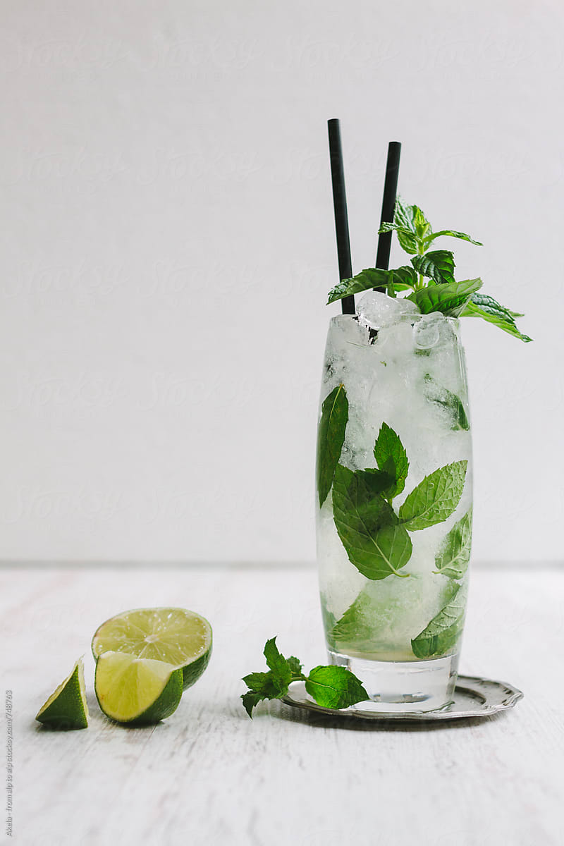 mojito long drink with fresh mint and limes on white background