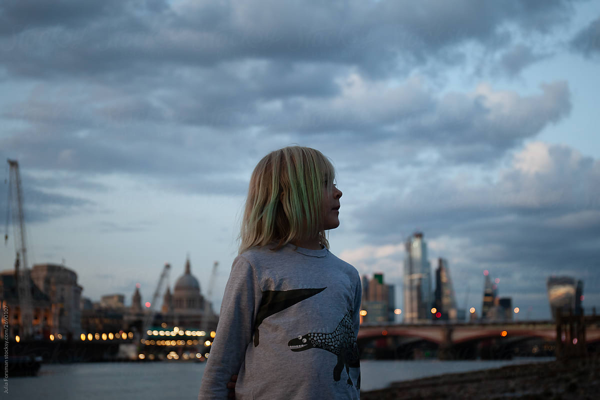 Profile of child with London skyline behind her.