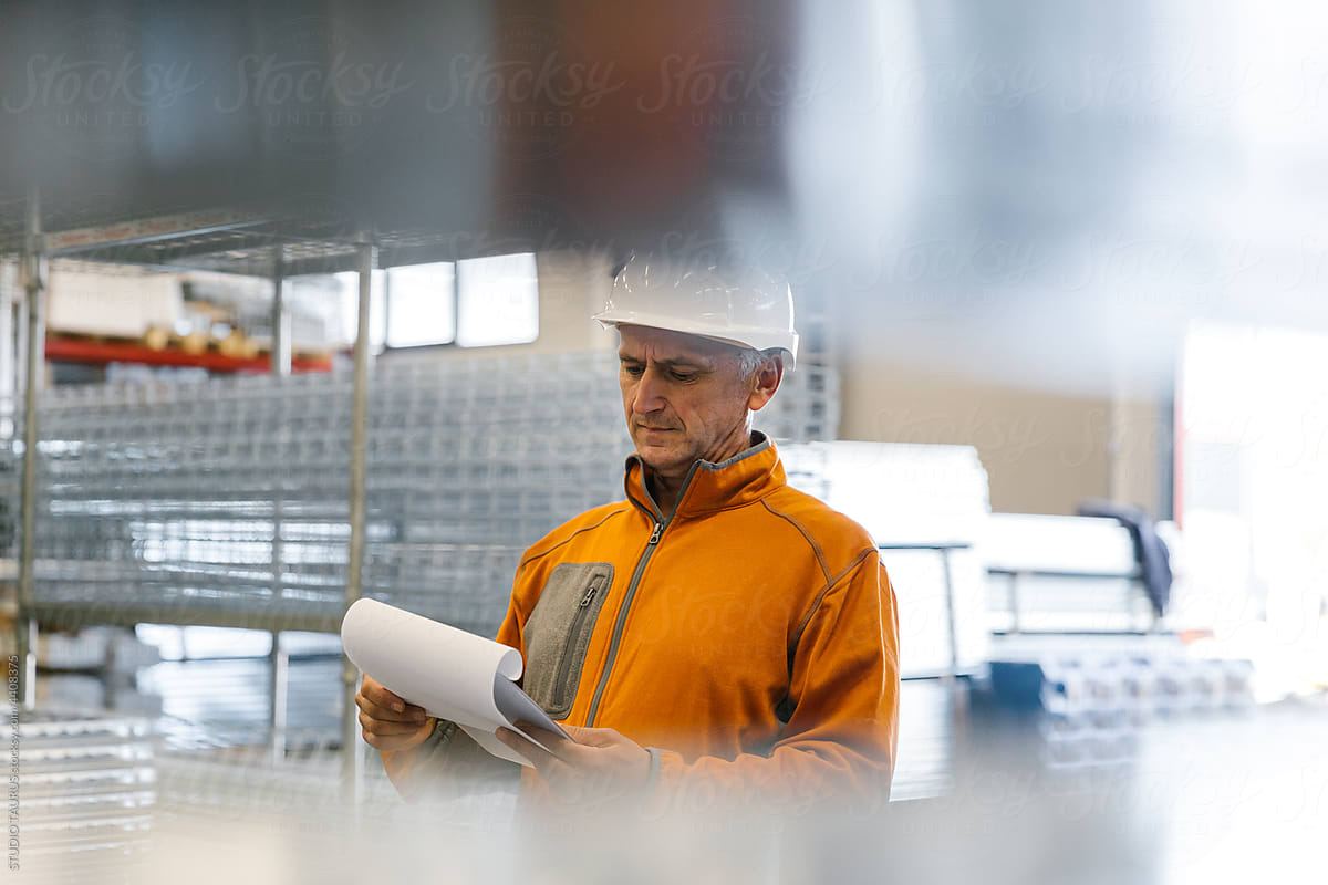 Man Checking Production Statistics Of Aluminium Profiles