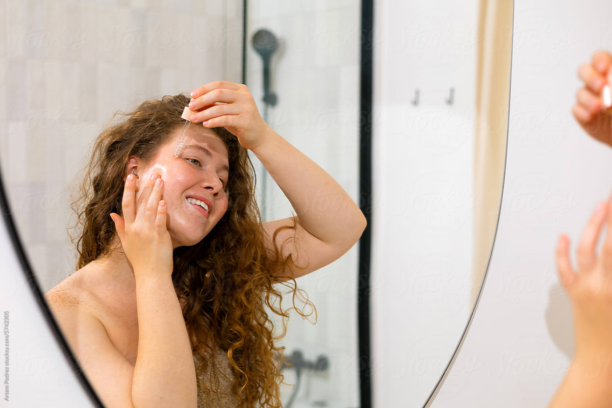 Self-Care Ritual: Woman with Dropper Serum in bathroom