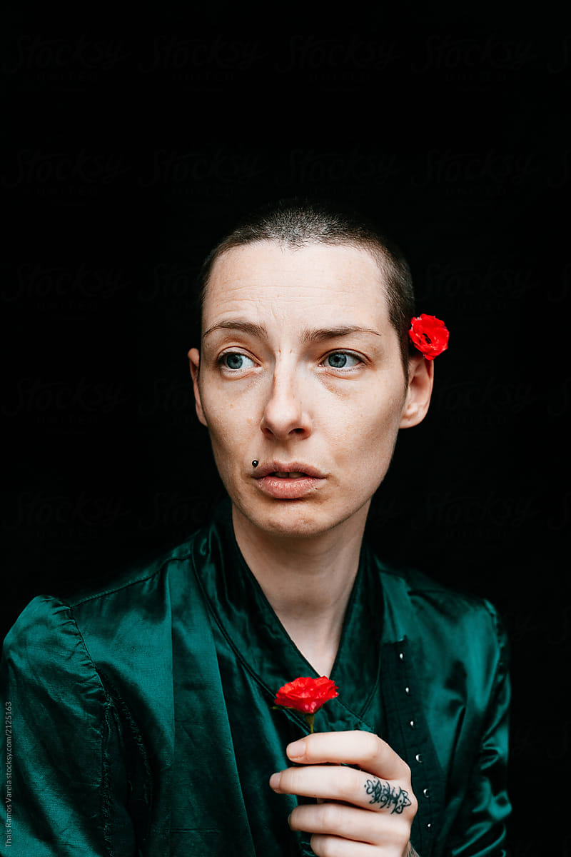 portrait of a woman in green outfit and red roses