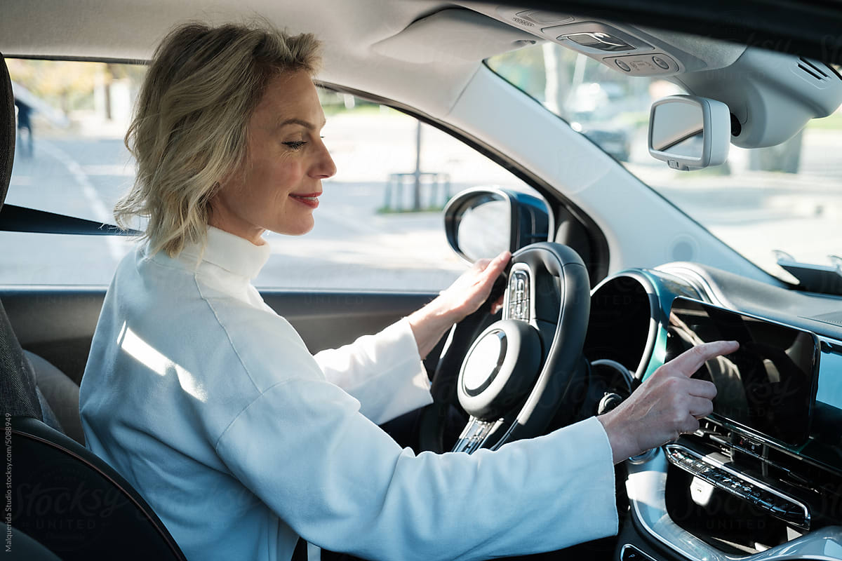 Woman touching GPS Navigator In Car