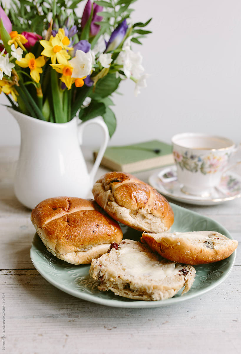 Hot cross buns, spring flowers and a cup of tea, with a blank notebook
