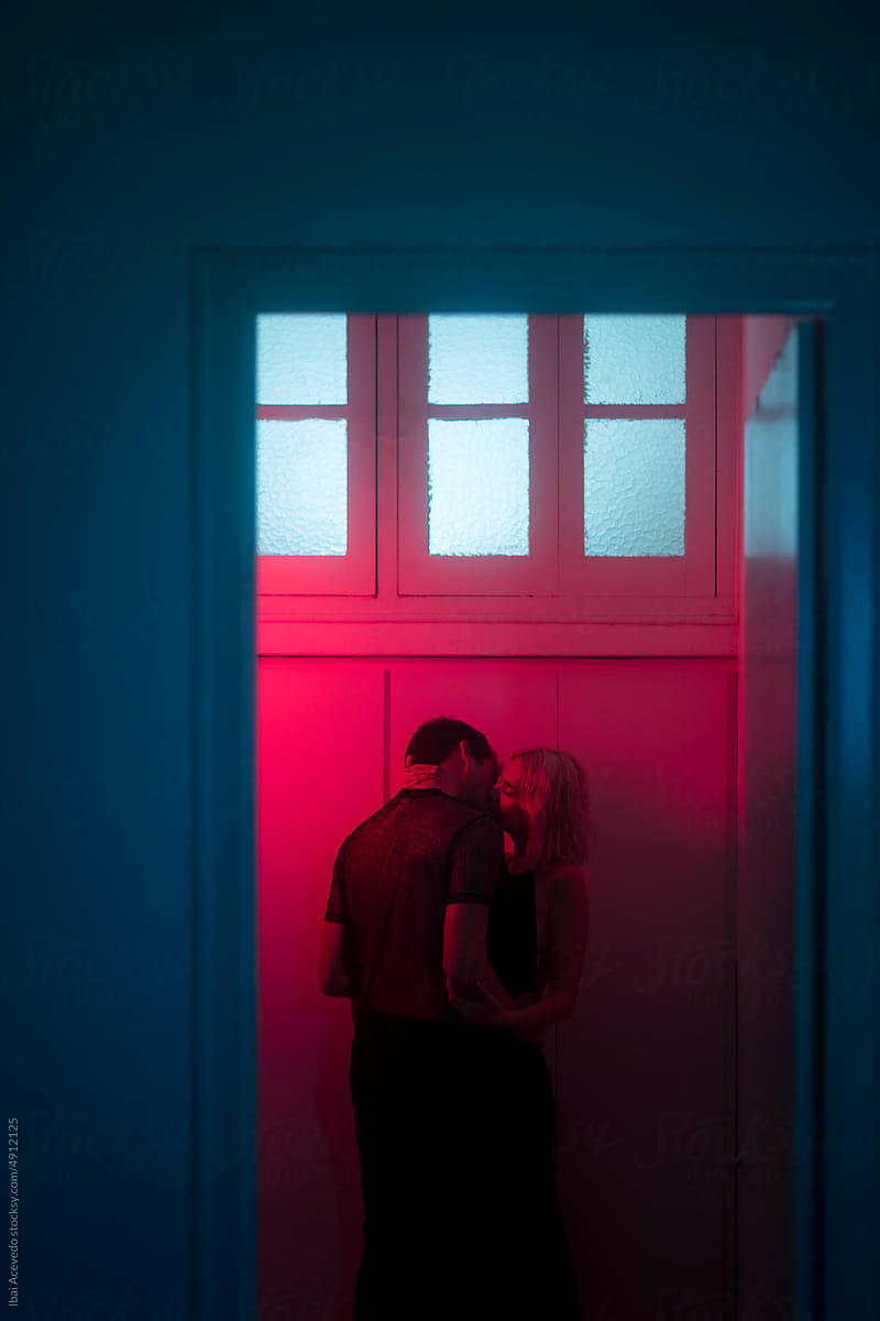 Dreamy couple kiss during intimate moment at the party