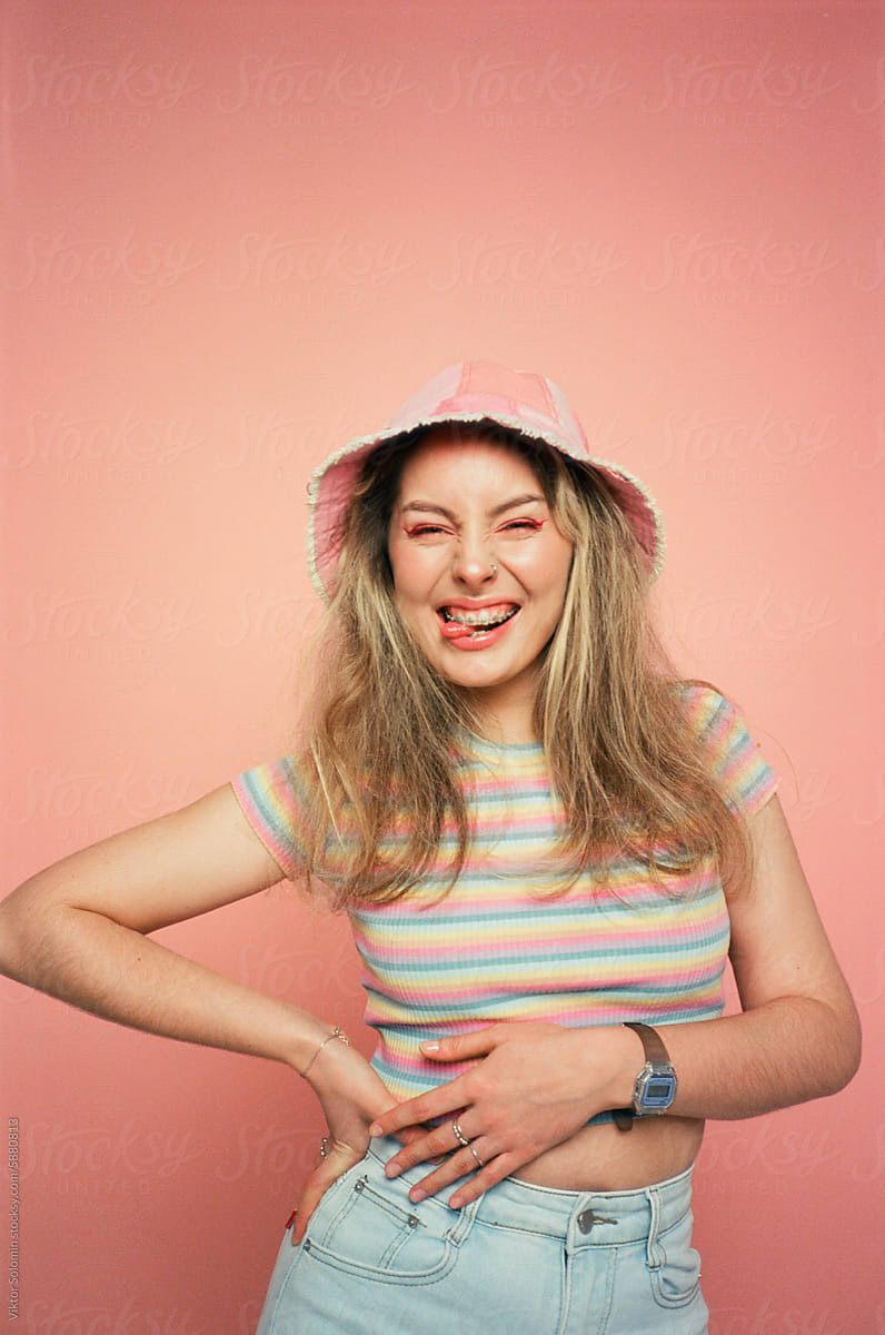 Smiling emotional woman in trendy outfit in studio
