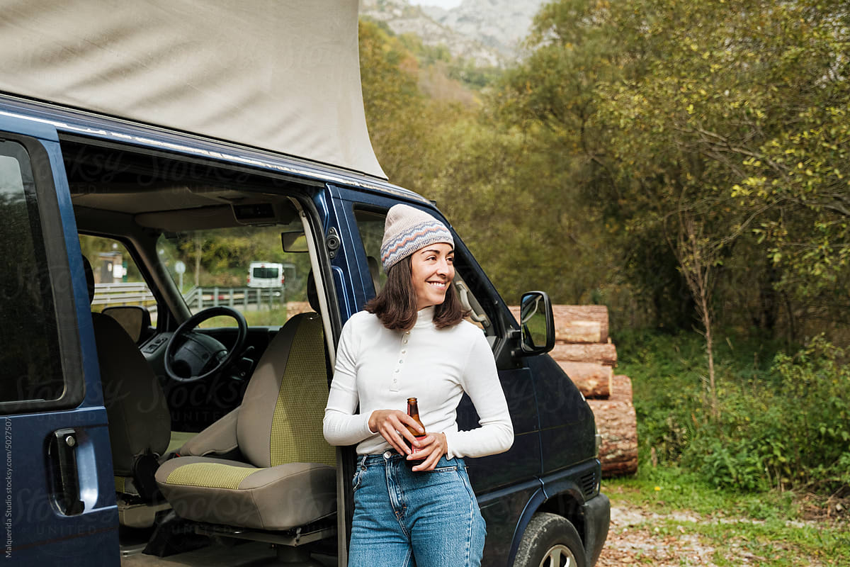 Woman traveling in nature with campervan