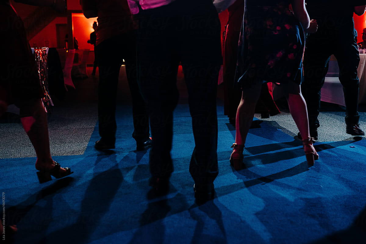 anonymous group of feet dancing at a party