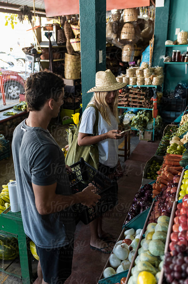Friends buying organic vegetables in a market